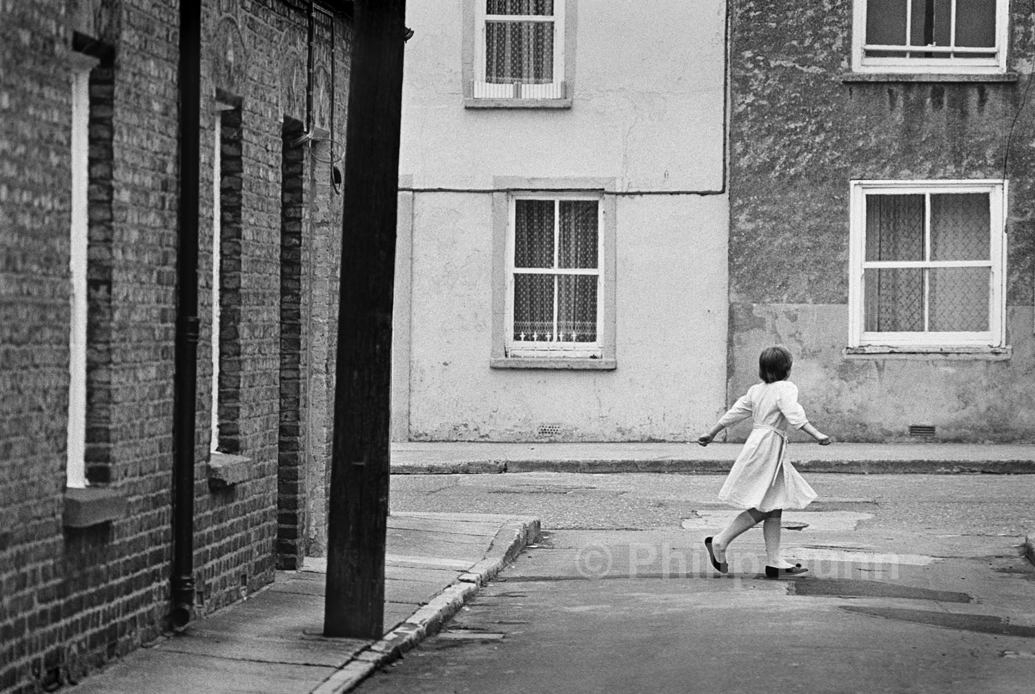 Street Photography Ireland - a girl twirls in her new dress